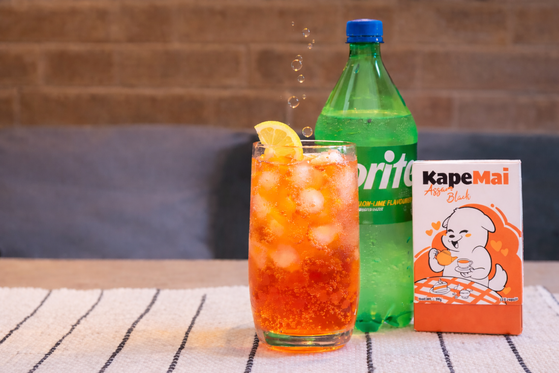 Assam Spritz cold brew tea. A bottle of sprite soda and Kapemai Assam black tea box and a glass with the cold brew tea